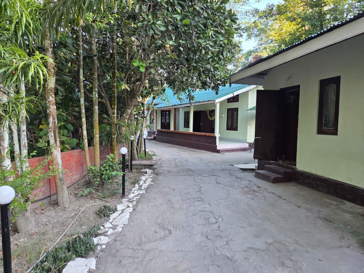 Green Reed Resort by Meenakshi property pathway surrounded by trees